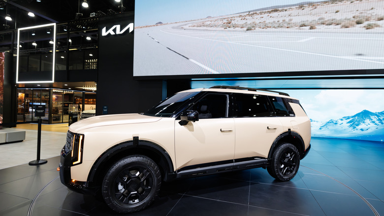 The latest version of the Kia Telluride on display indoors at a launch event, finished in white.