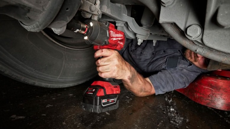 fixing car with Milwaukee impact wrench