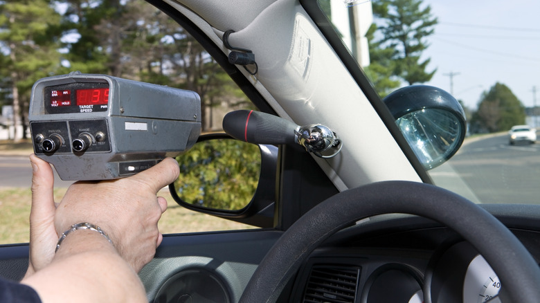 Police officer holding radar gun