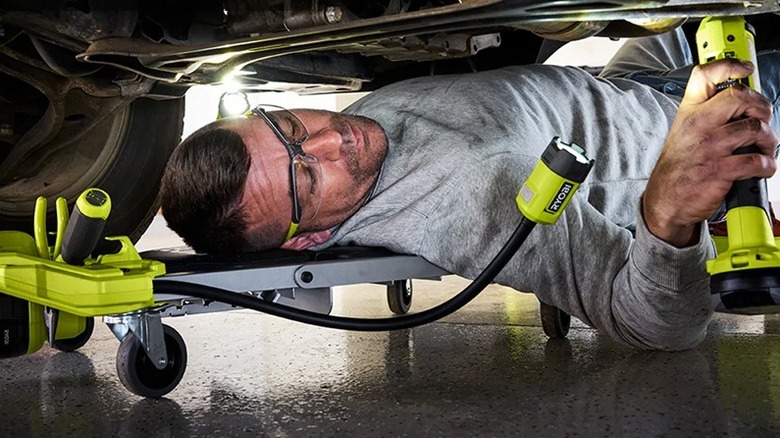 Person using Ryobi creeper seat