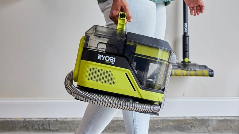 Person carrying Ryobi SwiftClean carpet cleaner
