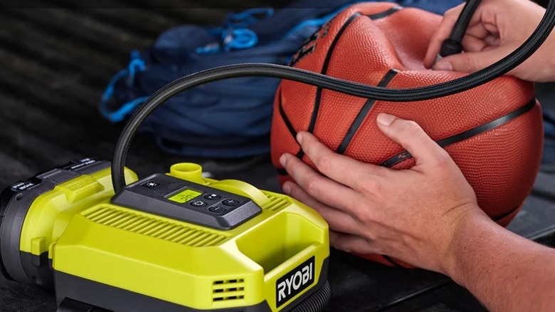Person using Ryobi inflator