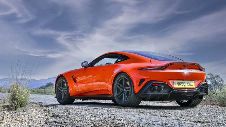 Orange Aston Martin Vantage in countryside
