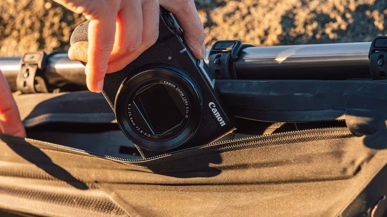 A person taking out the Canon PowerShot V1 from a bag