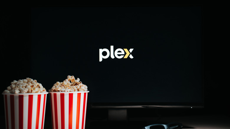Two buckets of popcorn in front of TV with Plex logo