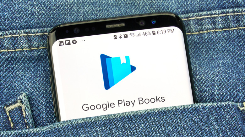 Google Play Books app on smartphone in jeans pocket