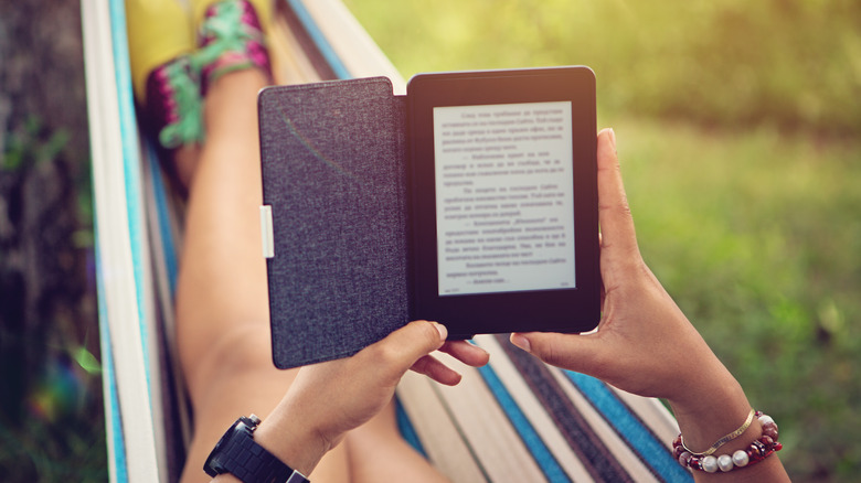 Girl reading an ebook on a hammock