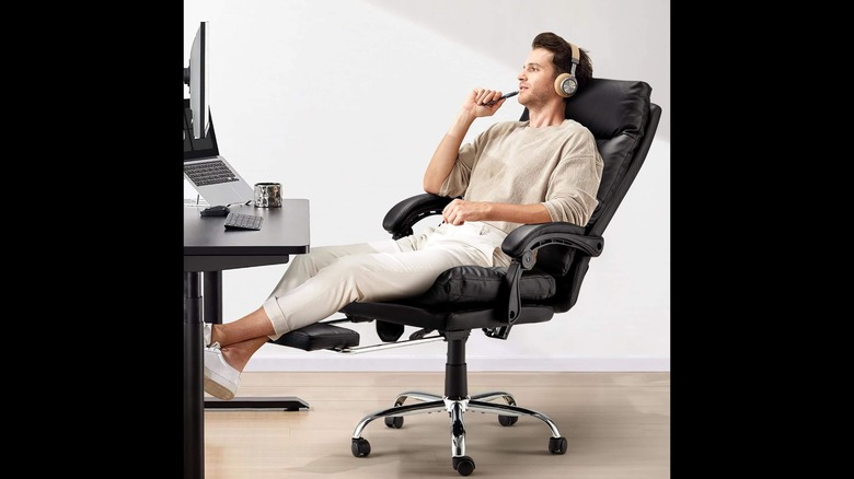 Man in reclining executive office chair