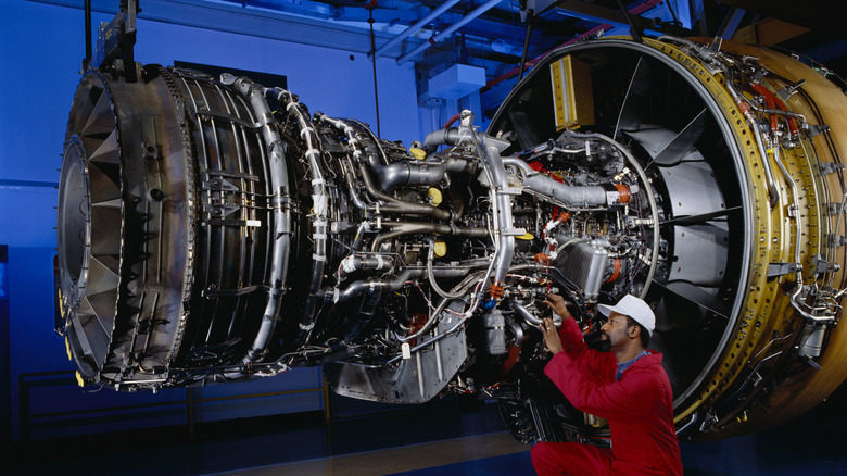 Man working on an open engine