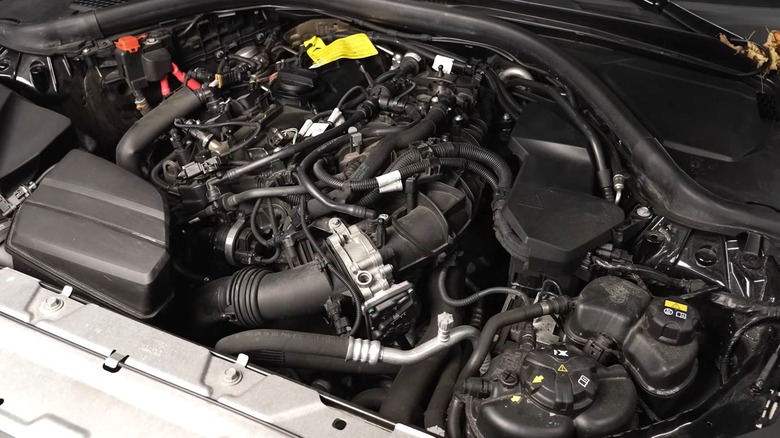 A modern tightly-packed Ford 2.3L Lima engine bay full of hoses, connectors, and reservoirs.