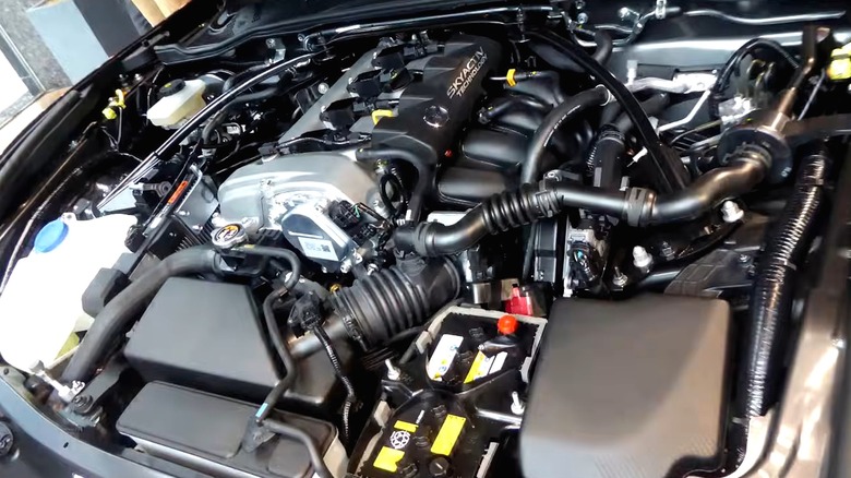 This is a Mazda engine bay showing the SKYACTIV valve cover and surrounding components neatly tucked under the hood.