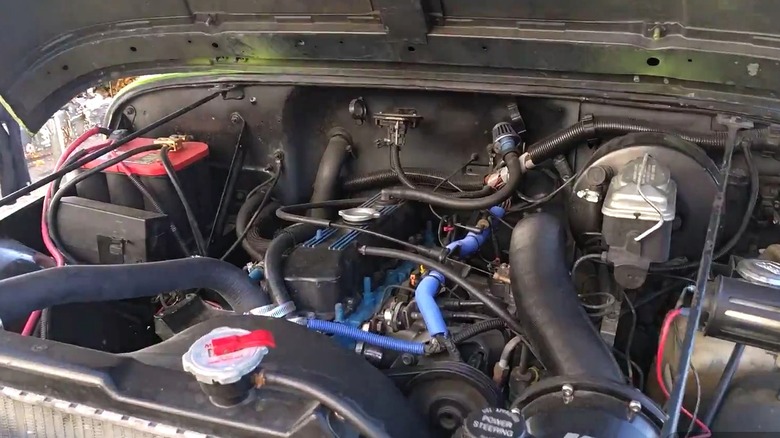 An engine bay of a AMC 2.5L four-cylinder.