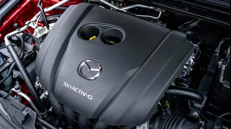 This is a Mazda SKYACTIV-G engine cover, complete with the badge and dual oil/coolant cap cutouts.
