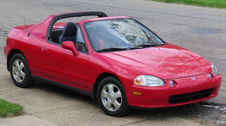 Red Honda Del Sol parked curbside