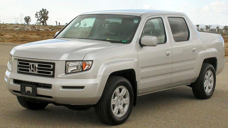 Silver Honda Ridgeline pickup in front of desert