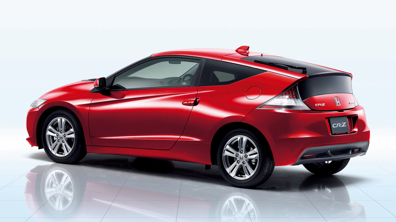 Milano Red Honda CR-Z hatchback seen from left rear against blank studio background