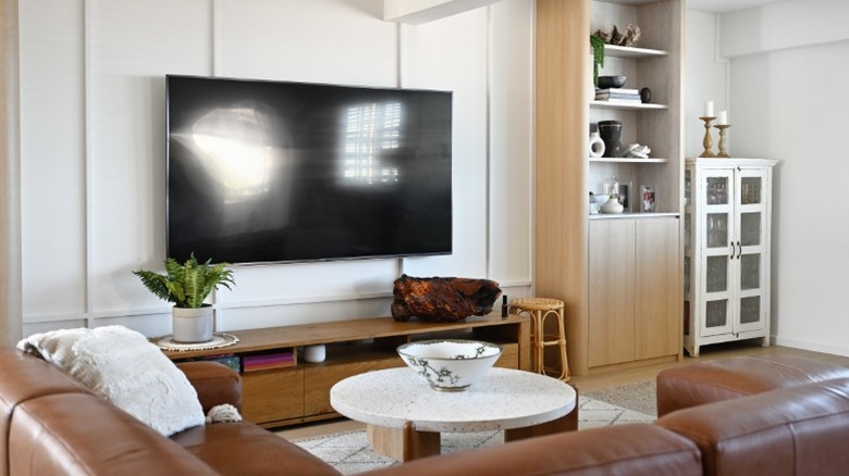 A TV reflecting glares from the window