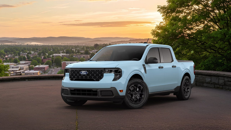 Light blue 2026 Ford Maverick XLT parked overlooking a city at sunset