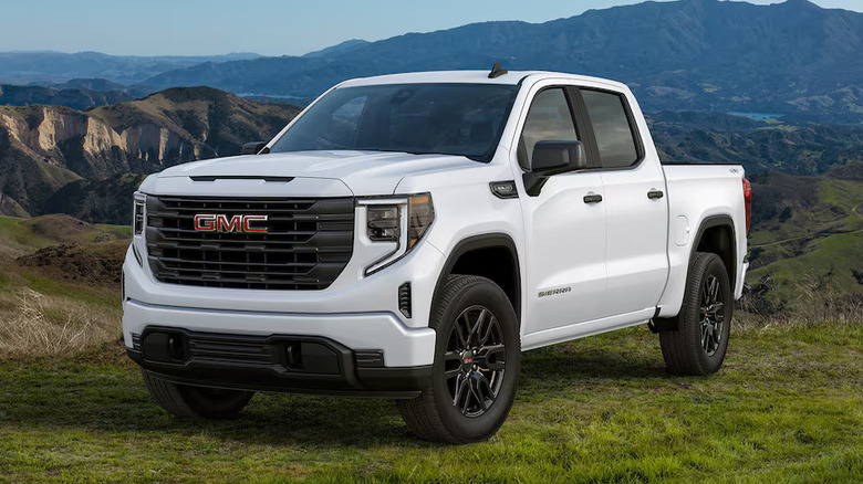 White 2026 GMC Sierra 1500 Pro parked outside with mountains in the distance