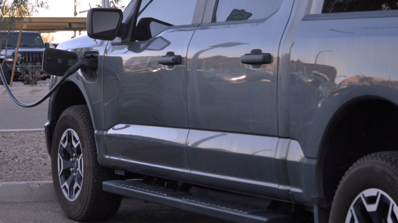Closeup of the side of a Ford Lightning EV truck charging