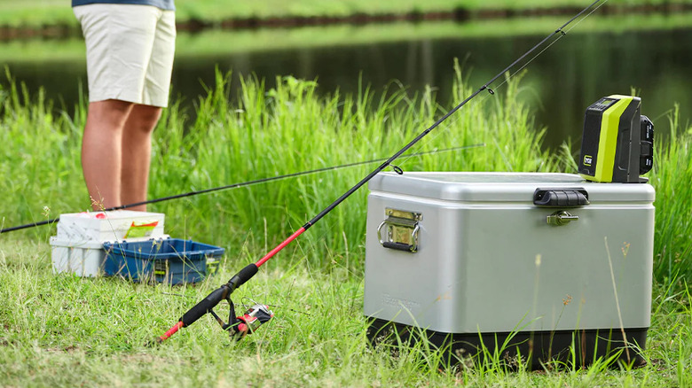 Person using a Ryobi compacy cordless radio while fishing.