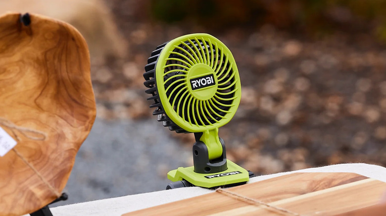 Ryobi USB Lithium clamp fan on an outdoor stall.