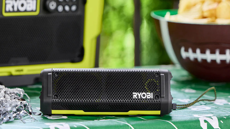 Ryobi USB Lithium compact speaker on a table outdoors.