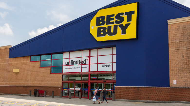 People walking outside a Best Buy store.