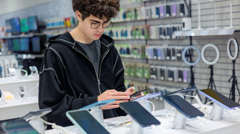 Person looking at a phone at a store.