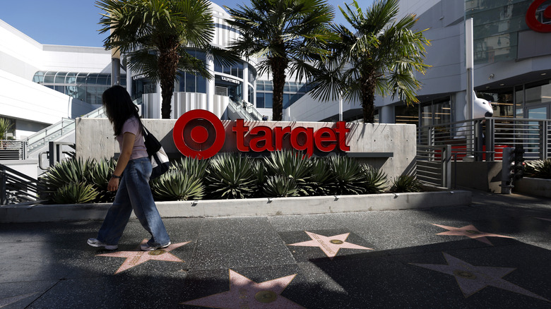 Picture of someone talking by a Target sign.