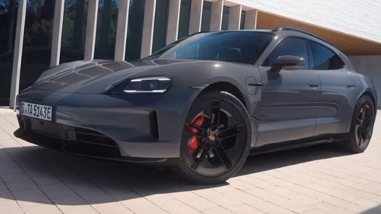 Porsche Taycan GTS Sports Turismo parked on a paved surface in front of a building