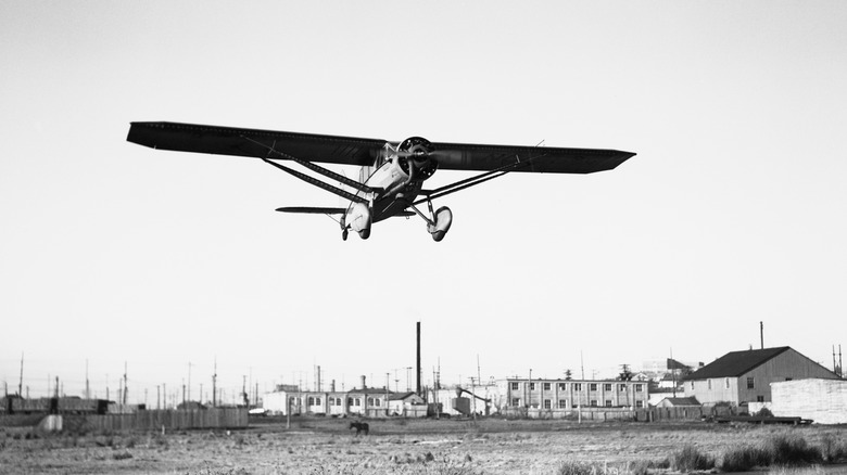 A black and white picture of a Bellanca Ch-300 SPL Pacemaker landing
