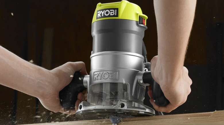 Ryobi's Fixed Based Router being used to smooth out edges on a piece of lumber