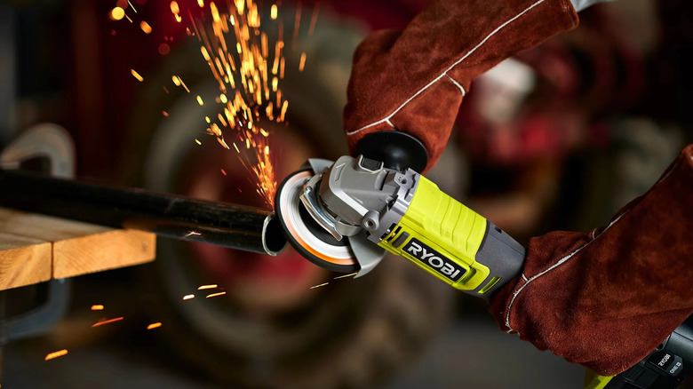 Ryobi angle grinder being used to carve and shape down a metal pole