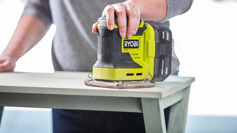 Ryobi 1/4 sander being used on a tabletop