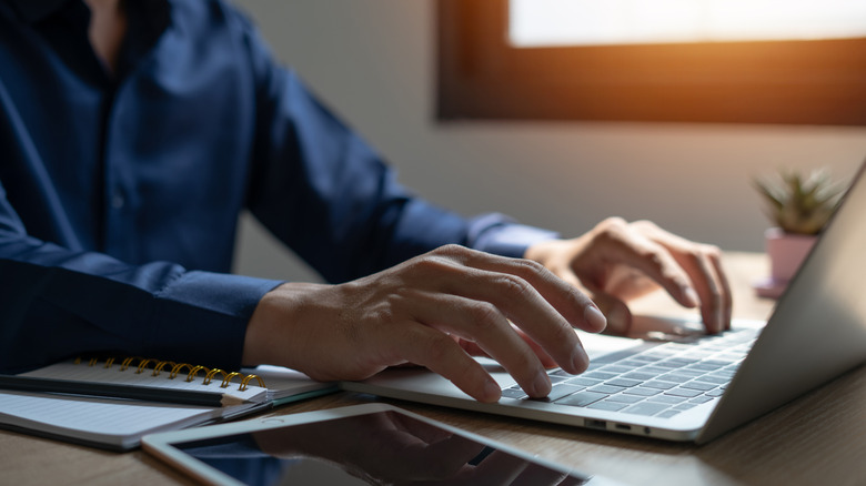 Man works at laptop