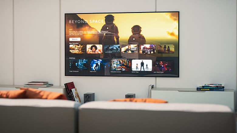 Wall-mounted TV displaying a streaming application interface inside a minimalist living room.
