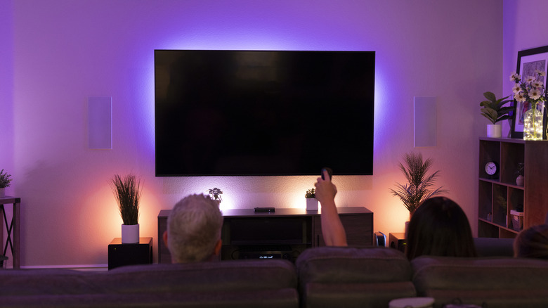 Wall-mounted television with ambient LED backlighting.