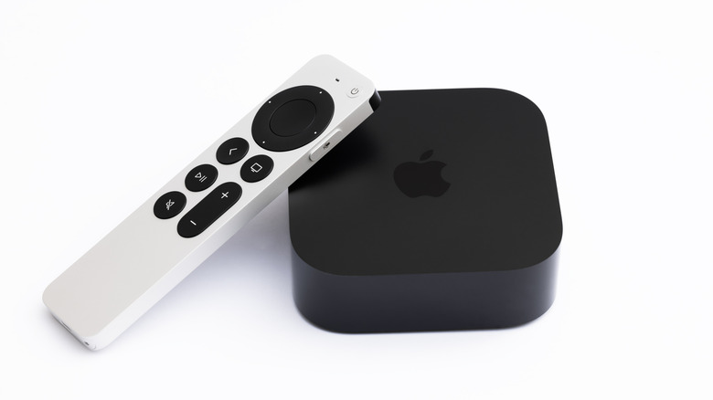 Apple TV box and silver Siri remote on a white background.