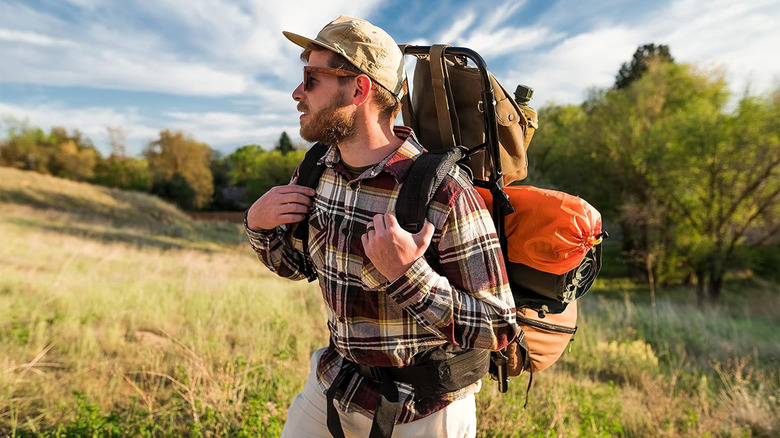 man with backpack in backpack frame