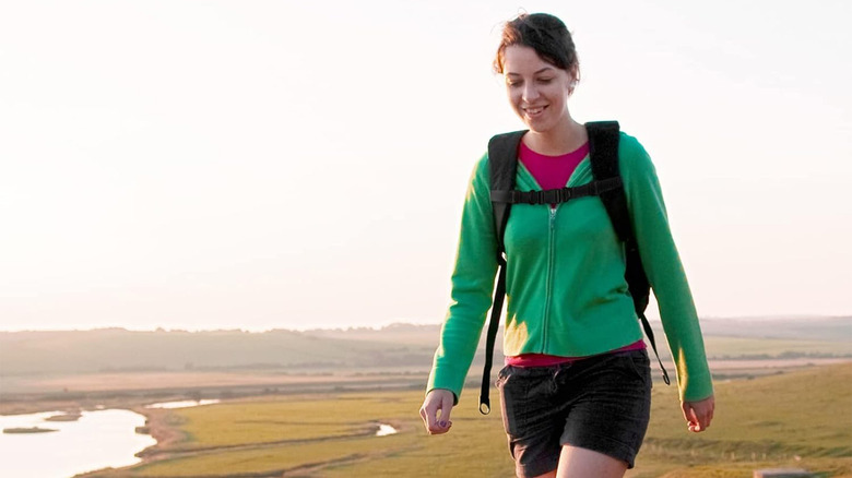 woman walking outside with a backpack
