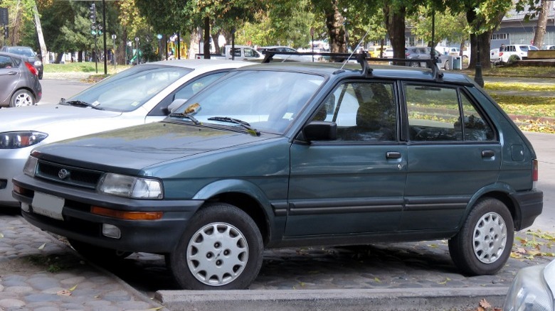 A red facelifted Subaru Justy
