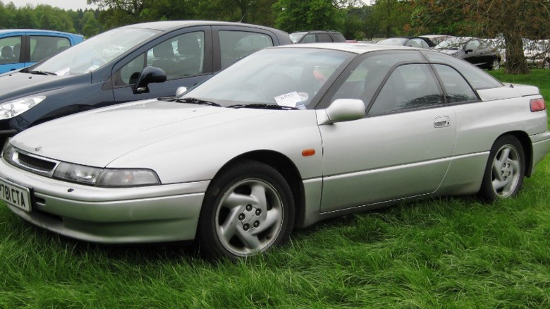 A grey Subaru SVX at a fair