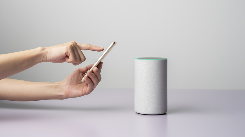 Person controlling Bluetooth speaker