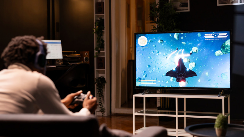 Man playing video games TV