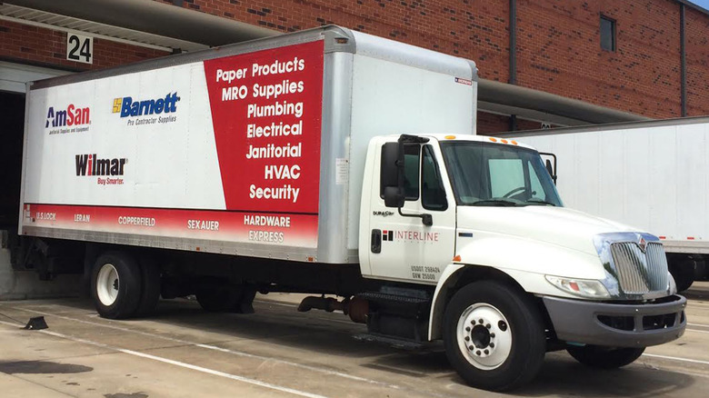 A cargo truck at an unloading dock with Interline Brands logo