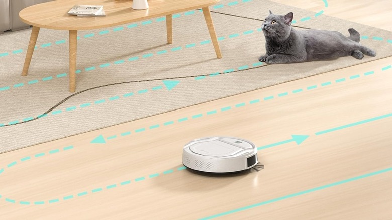 Lefant robot vacuum cleaning the floor with a cat and table on a carpet