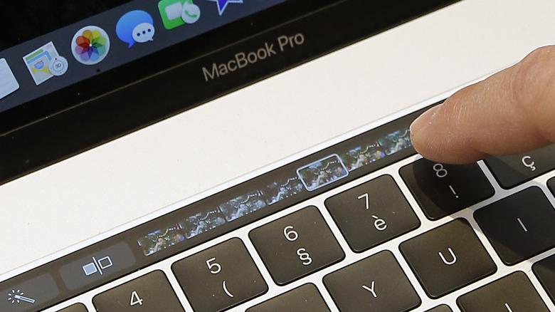 A finger on the MacBook Pro Touch Bar