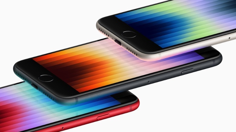 A diagonal stack of three iPhone SE smartphones showing the iconic Home Button