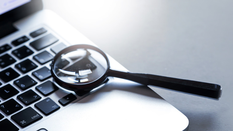magnifying glass on a laptop keyboard